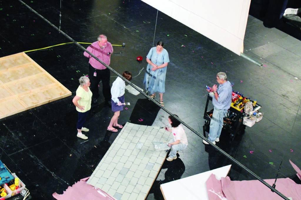 MATT SCHICKLING / WIRE PHOTOS Crew members work onstage at Mitchell Performing Arts Center building sets, working on lighting and sounds and attending rehearsals for this weekend's performance of Louisa May Alcott's Little Women.html-charsetutf-8