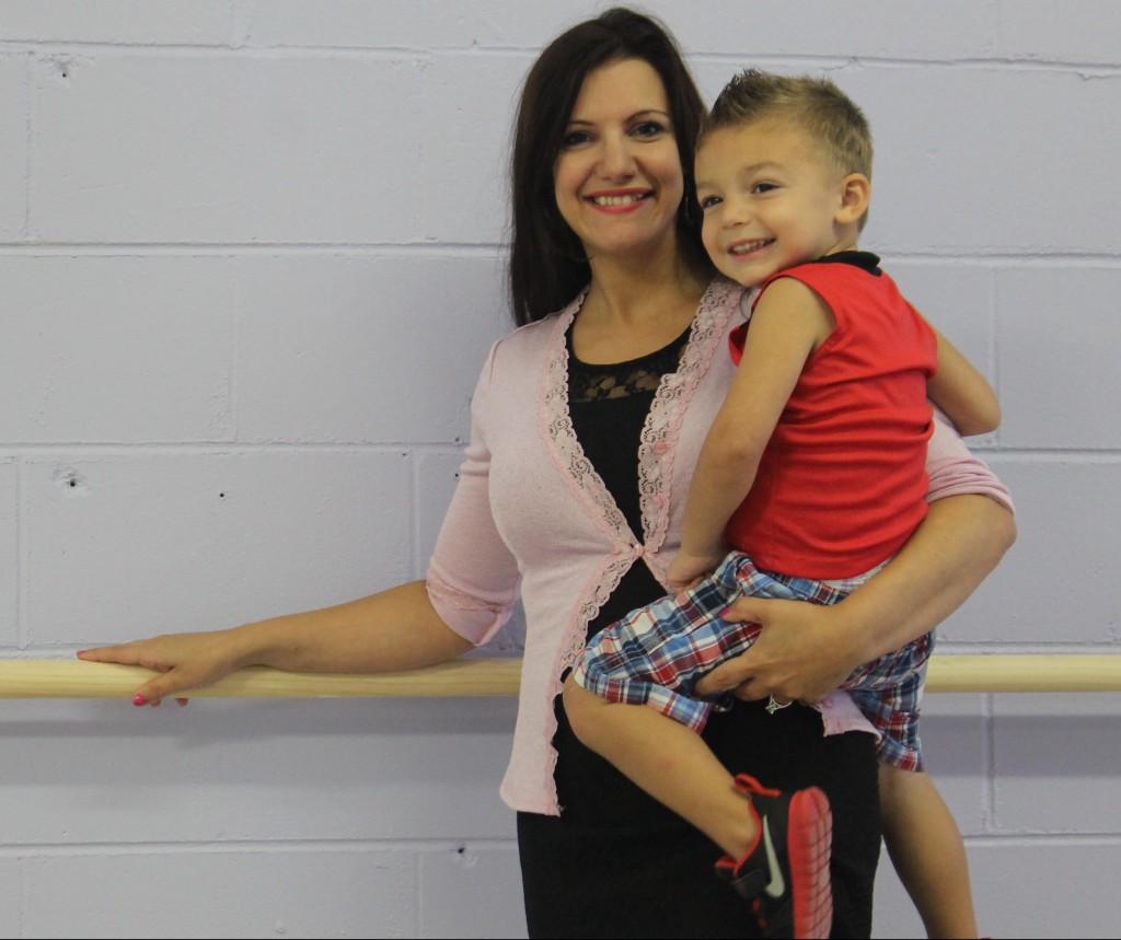 JACK FIRNENO / WIRE PHOTO Gabby Favoroso smiles with her son at Standing Ovations, a new performing arts center she launched this month in a storefront on Route 13 near Bath Street. The studio features a variety of classes including ballet, tap dancing, singing and acting.html-charsetutf-8