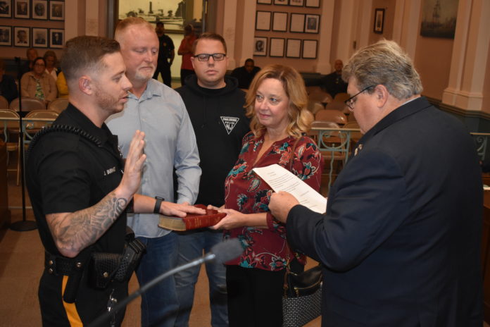 New Police Officer! Albert J. Countryman Jr./Gloucester City News James Burkhardt takes his oath of office as the newest Gloucester City Police officer from Mayor Dayl Baile while looking on is his father, retired Gloucester City Lieutenant Steve Burkhardt, during the City Council meeting on Monday, Sept. 25.